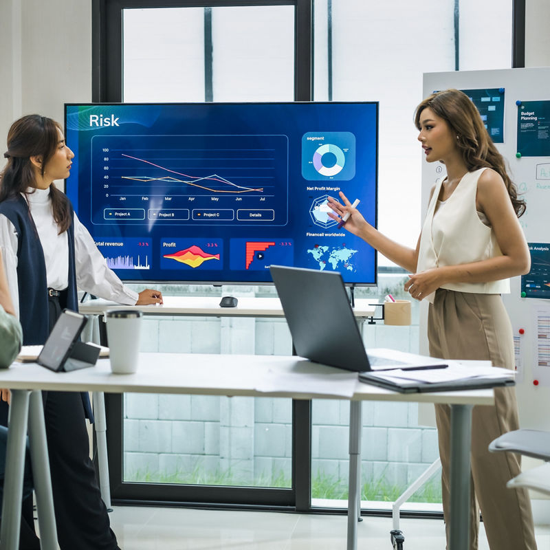 Woman leader presenting data and strategies in a modern office