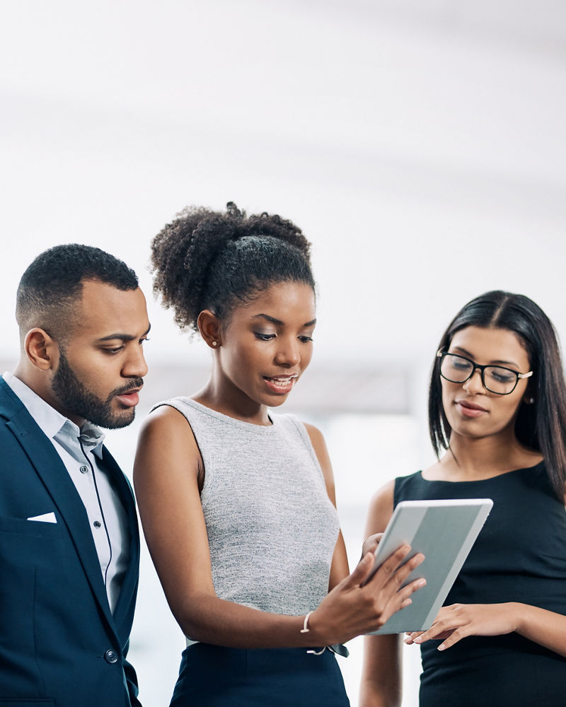 Shot of a business team using a digital tablet while having a meeting