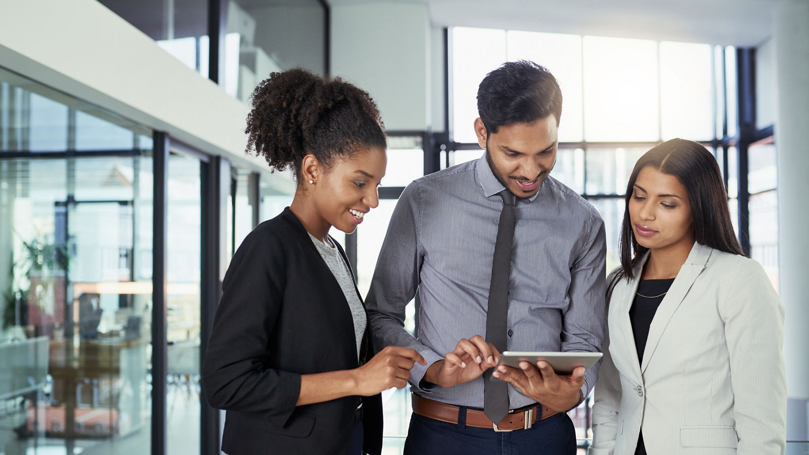 Shot of a group of business people using a digital tablet together in an office