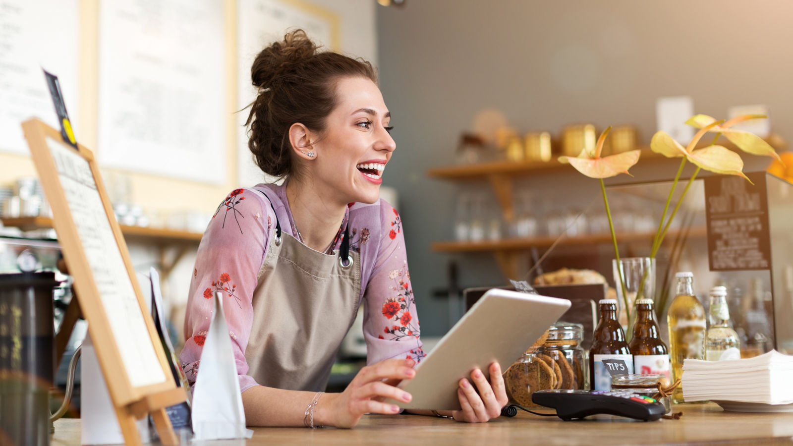 Young woman using digital tablet in coffee shop