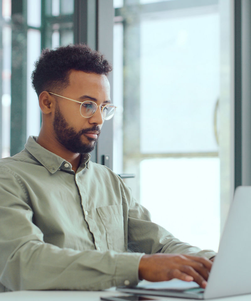 Computer science worker using laptop in office