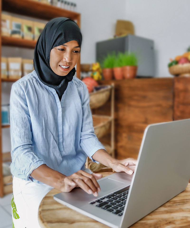 Shot of a local business owner happy on computer