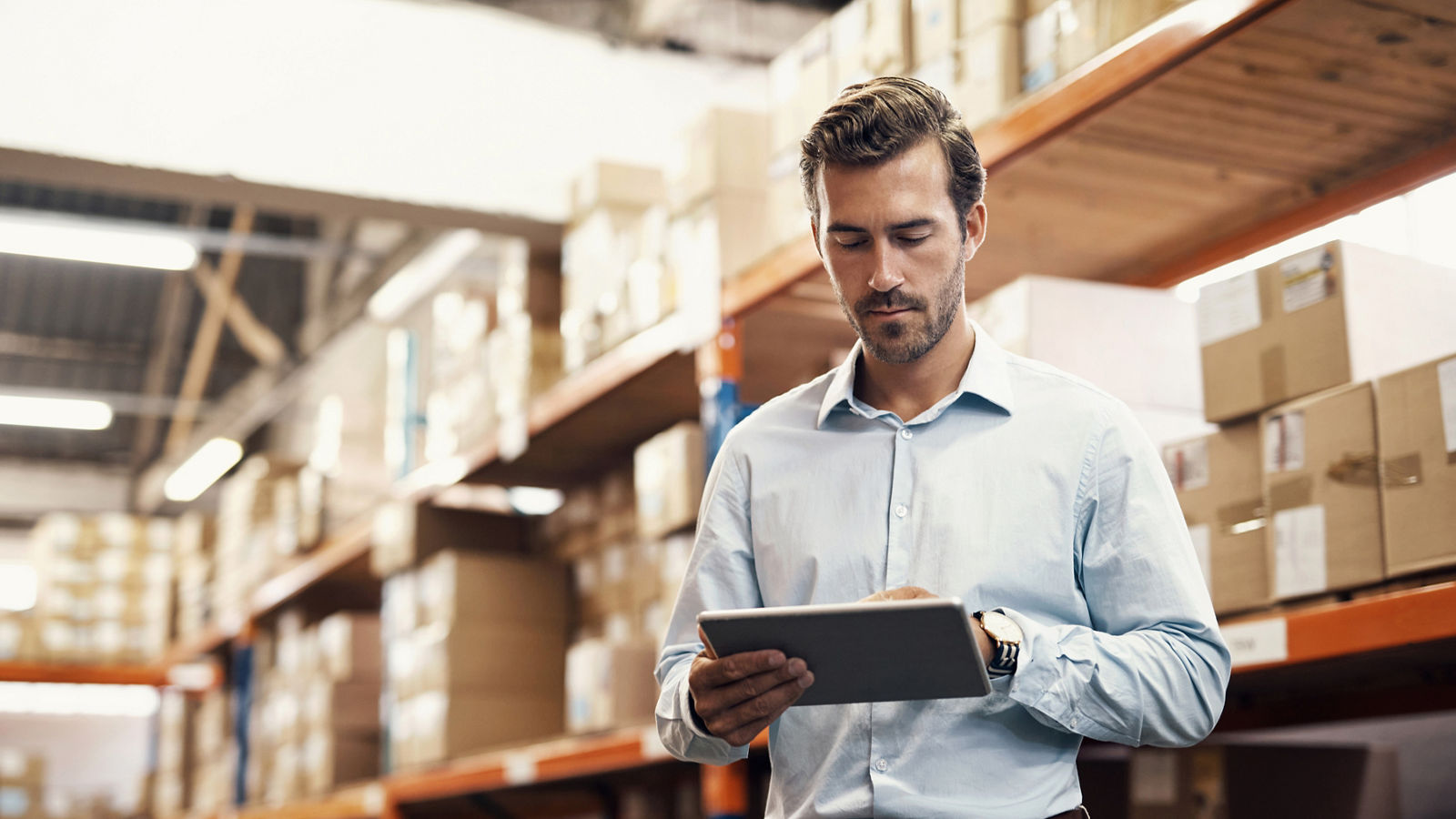 Shot of a man using a digital tablet while working in a warehouse