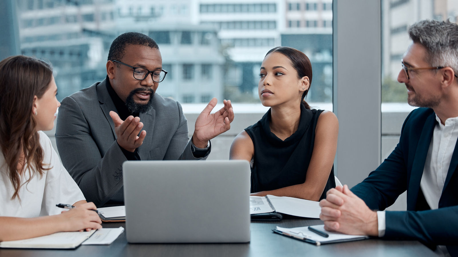 Workers in office conference room discussing subject