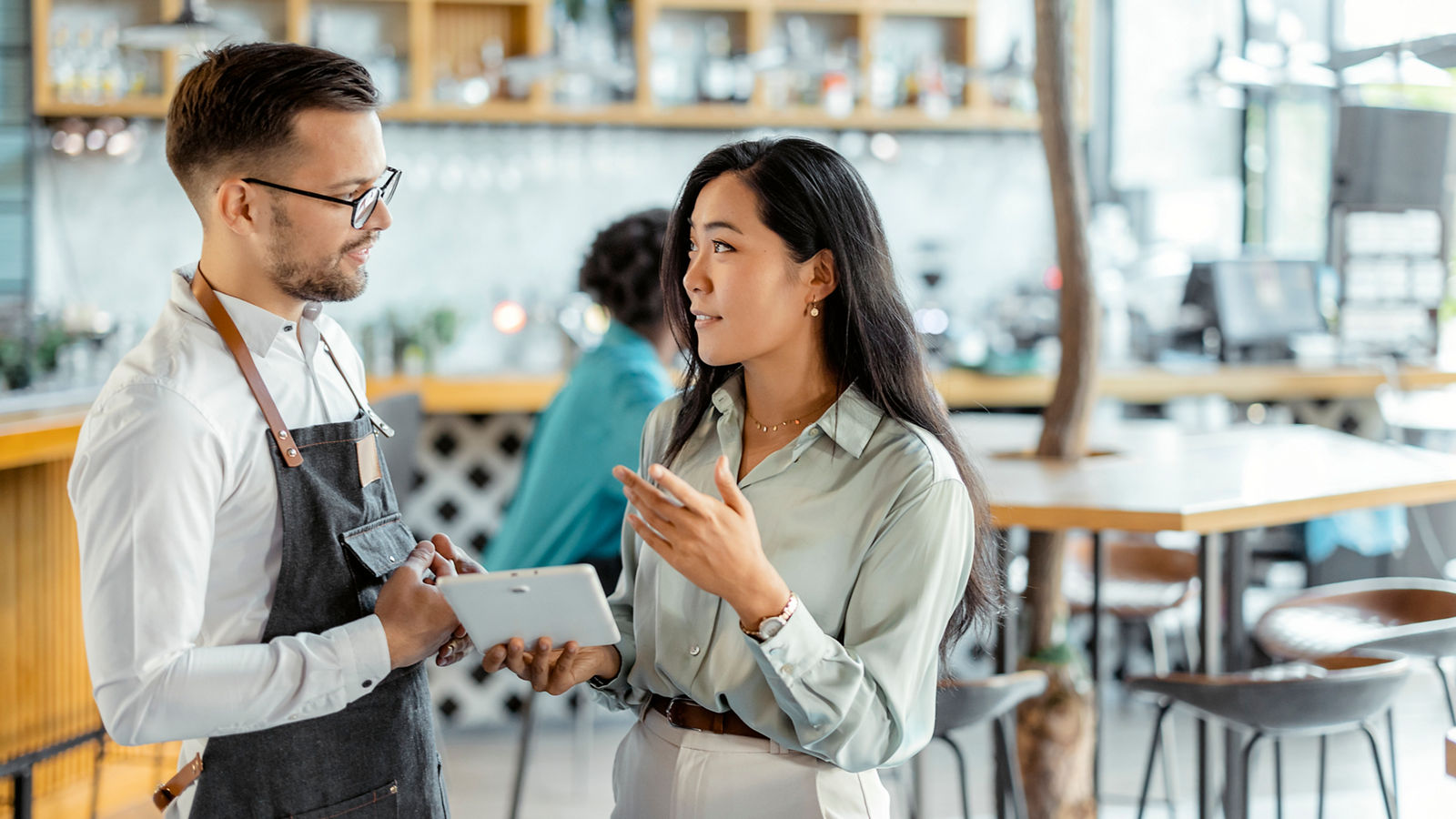 Lender speaking with small business owner of a cafe