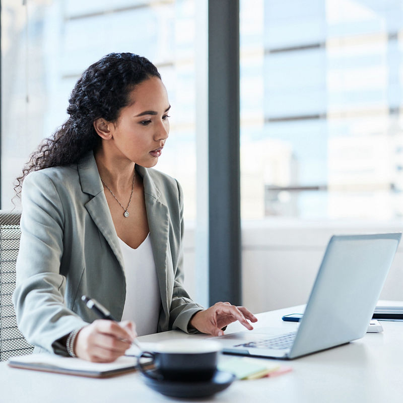 Woman looking at laptop in office