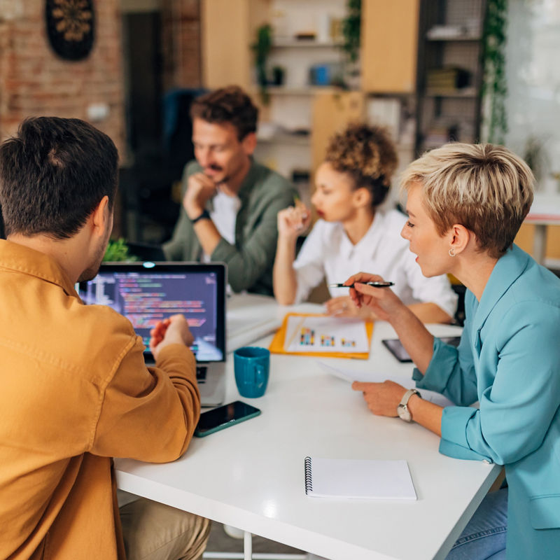 A small group of developers work together to solve coding problems.