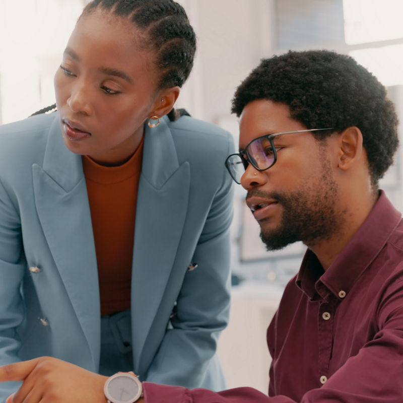 Computer, advice and business people planning for collaboration, ideas and workflow management. Black man, woman and discussion at desktop technology in office