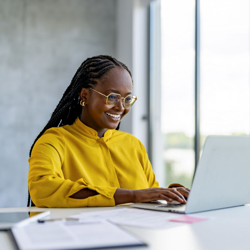 Lady Using Laptop Working Online Sitting In Office