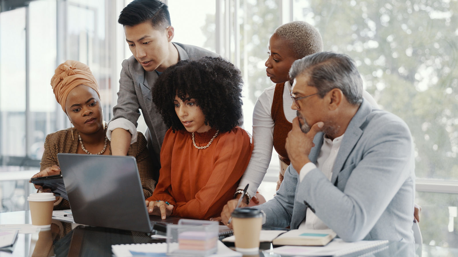 Business people having conversation with laptop in office