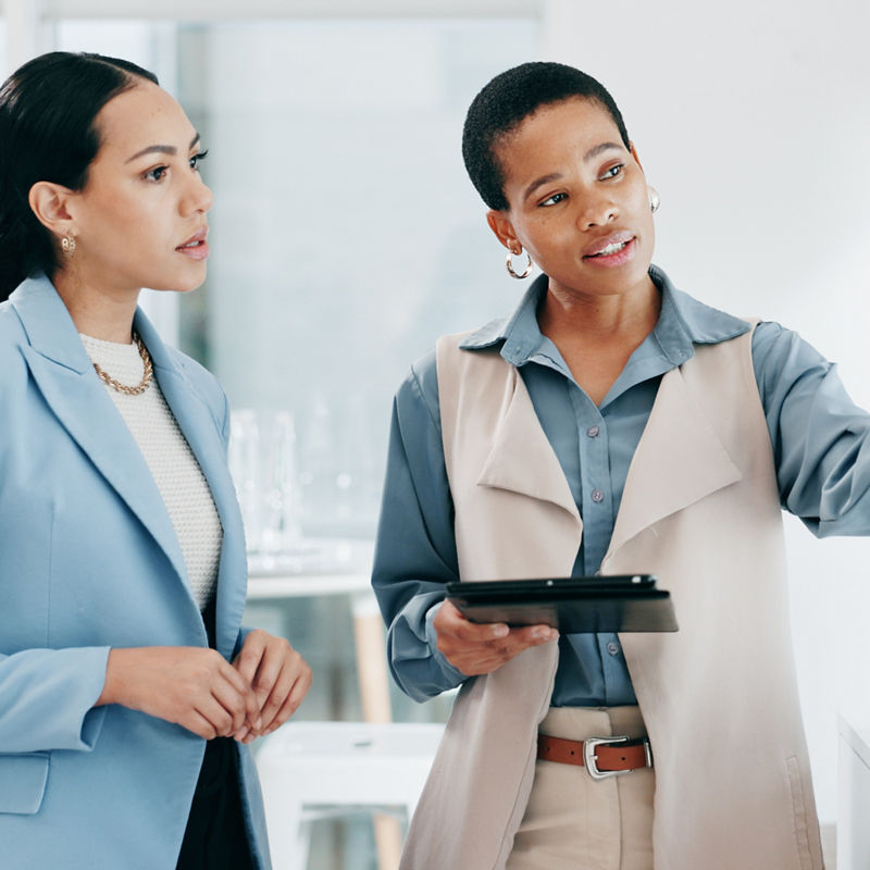 Data, presentation and women with tablet in the office for charts, graphs and statistics planning, Discussion, technology and financial advisors analyzing stock market in collaboration at workplace.