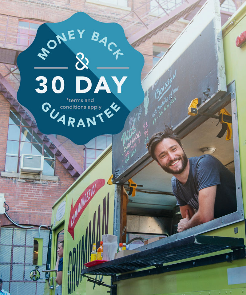 Adult man with beard smiling at clients in food truck in a city street on a bright summer day. Horizontal full length outdoors shot with copy space. This was taken in Montreal, Canada.