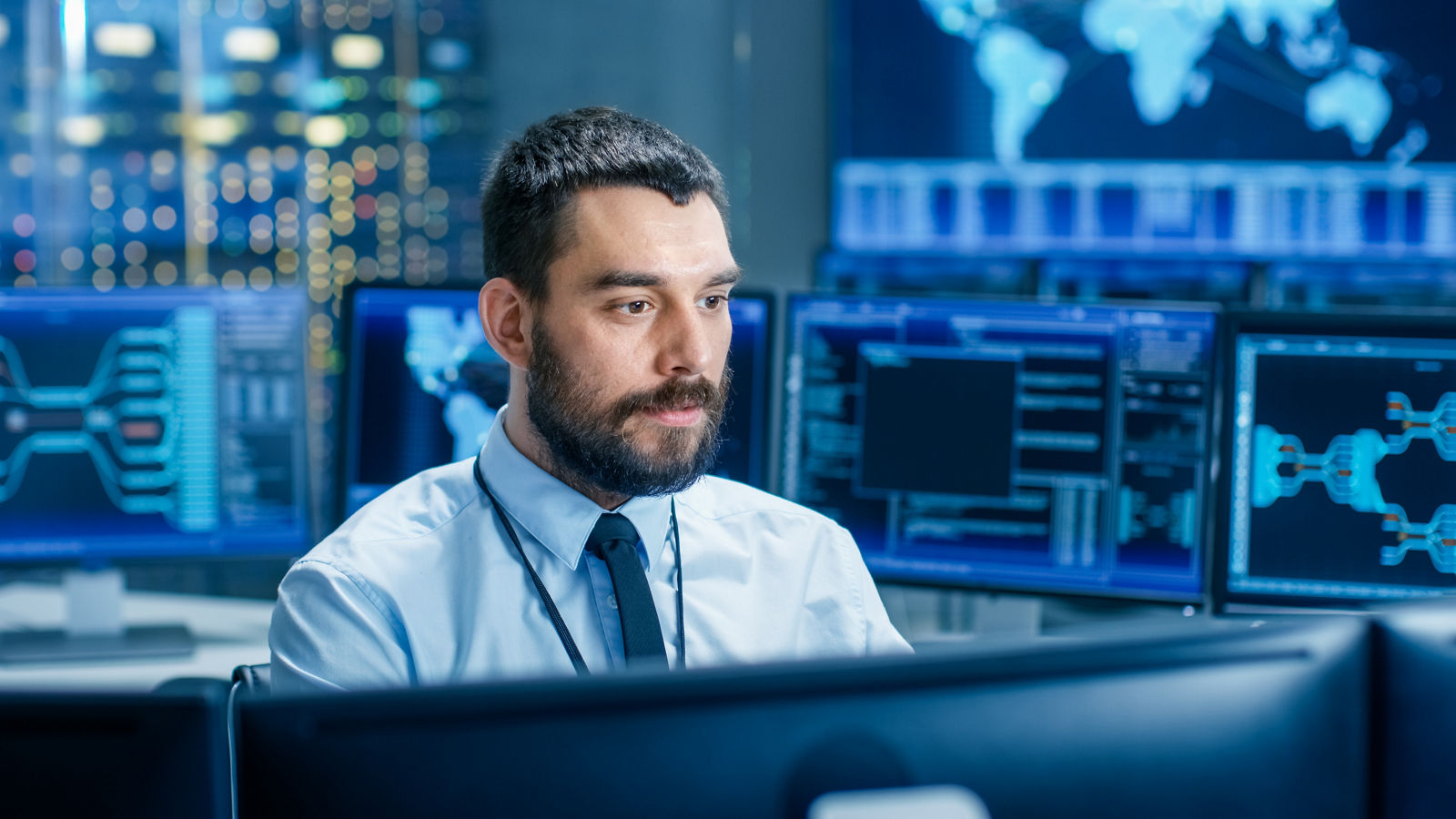 Security guard watches monitors in surveillance room