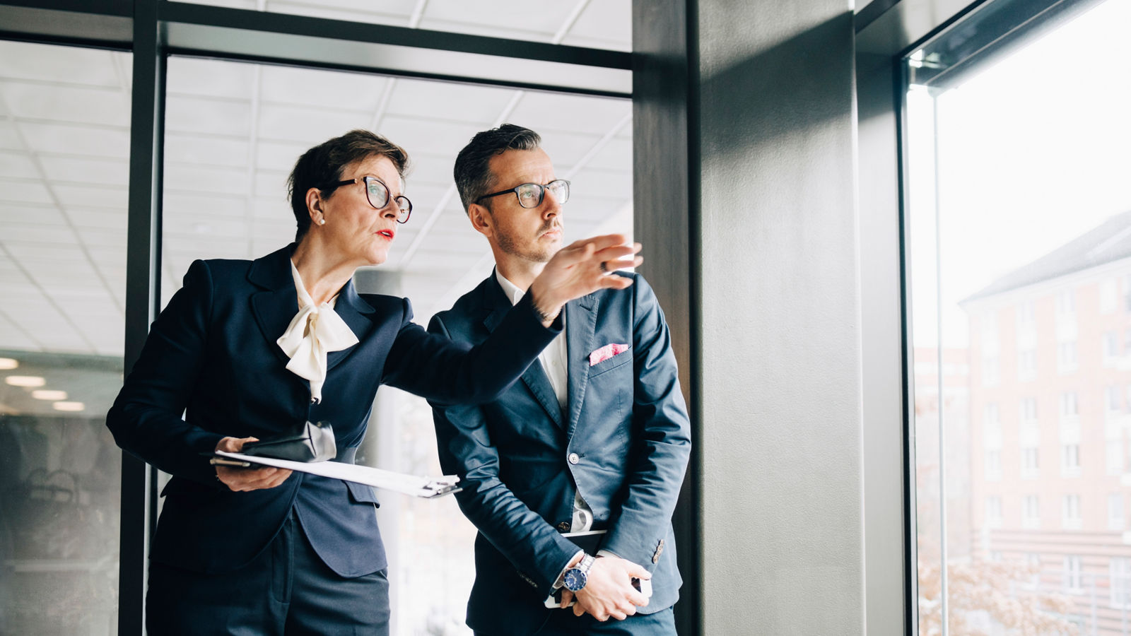 MAN AND WOMAN STANDING ON WALL