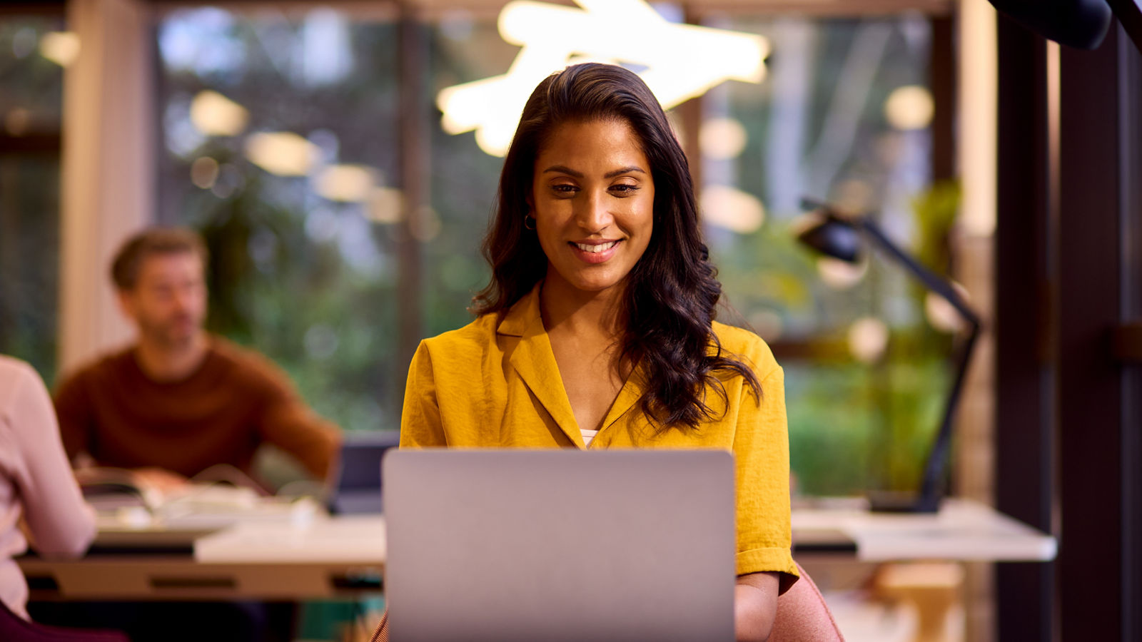 Businesswoman Working On Laptop At Desk In Office