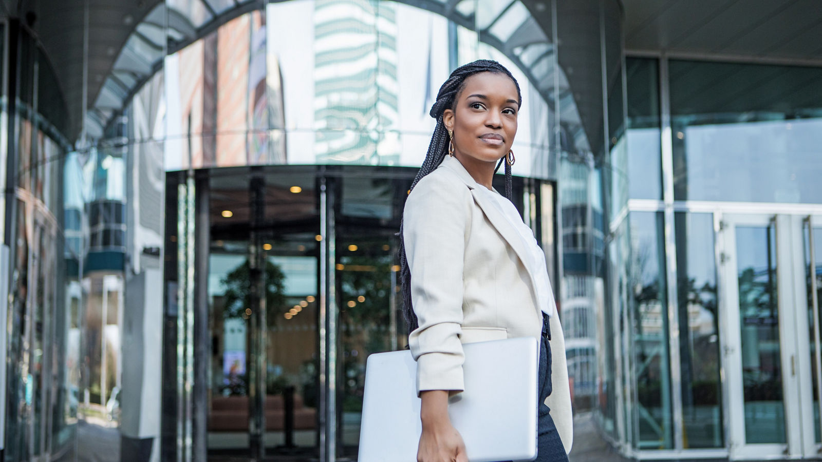 Woman standing confidently outside of her office building