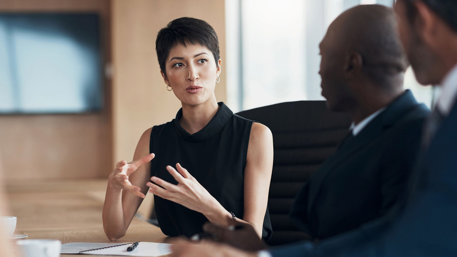 Woman leading business meeting inside of office