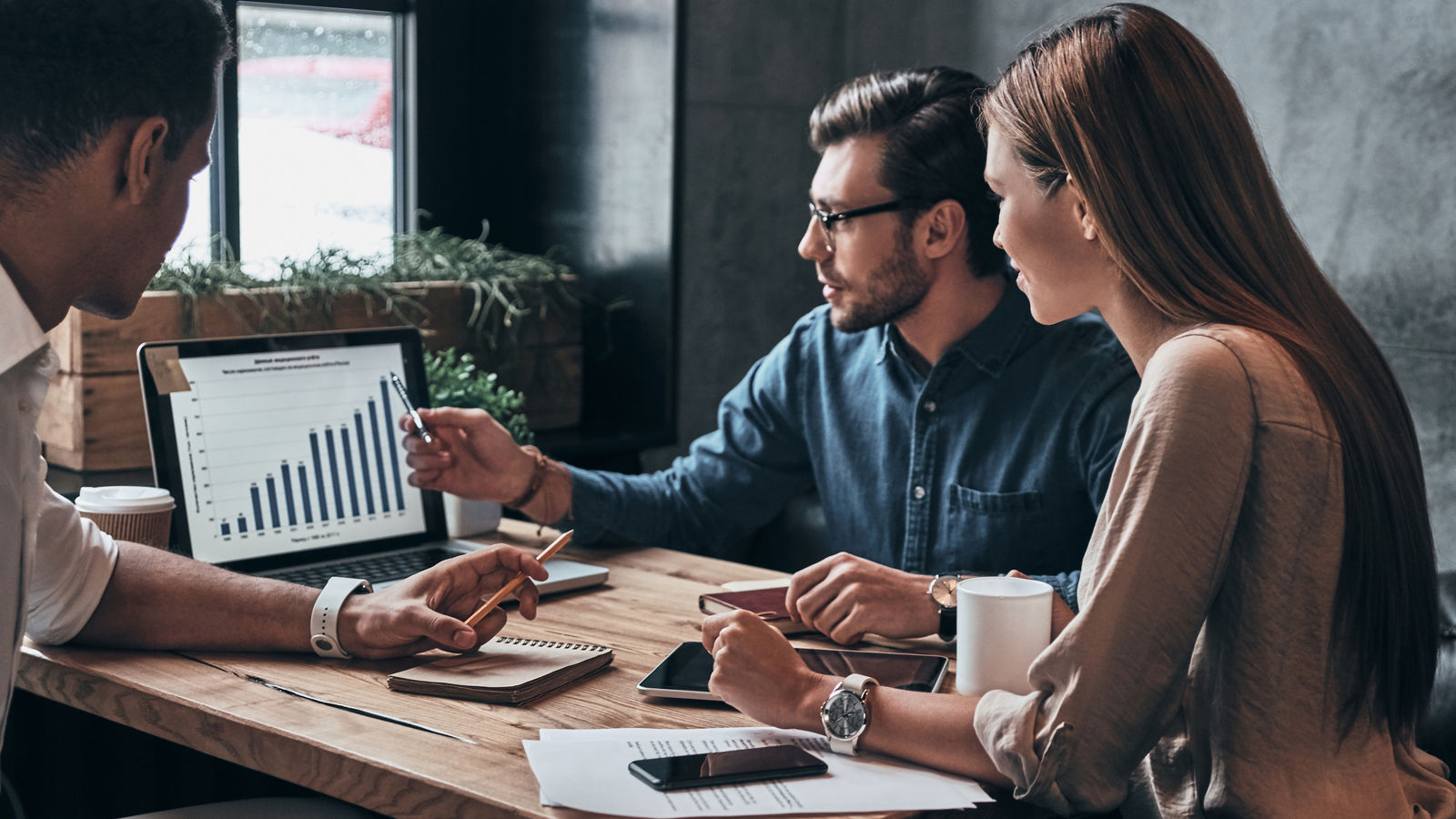 Business professionals. Group of young confident business people analyzing data using computer while spending time in the office