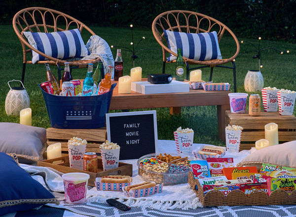 Backyard movie night with popcorns, theater boxed candy, drinks, blankets, pillows, rugs & more.
