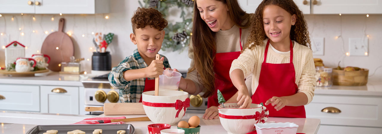 Family making cookies in a kitchen decorated with decor from pOpshelf and Christmas mixing bowls, cookies cutters, baking pans & more.