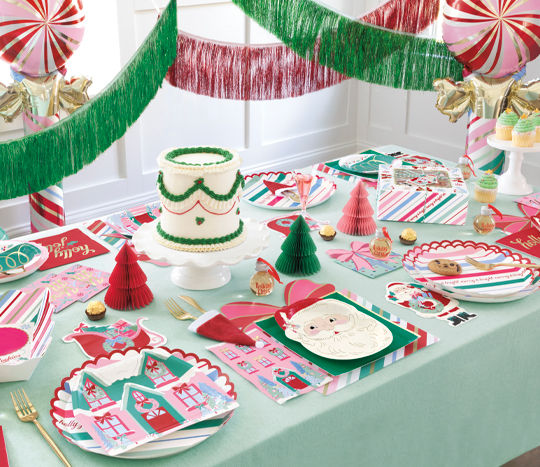 Christmas tablescape with santa plates, napkins, cutlery, balloons, streamers and more