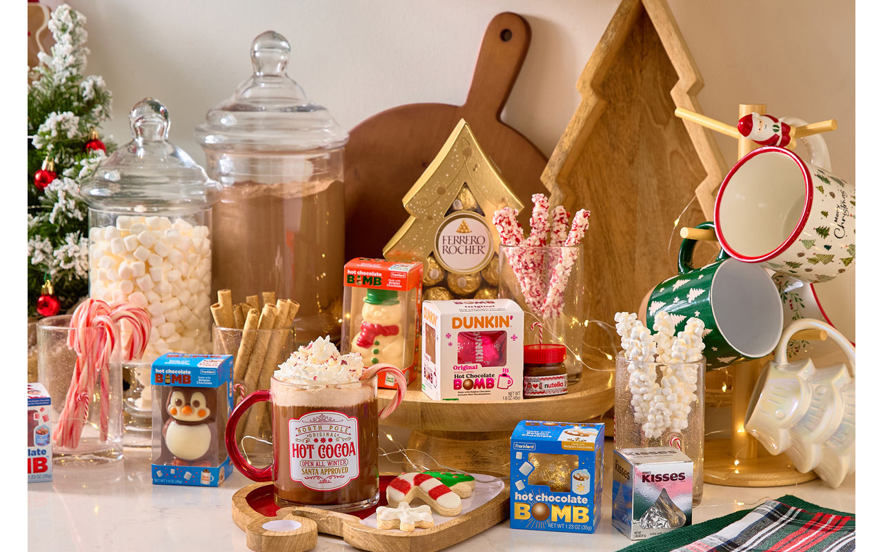 Hot cocoa bar with cocoa bombs, candy stirrers, Christmas mugs, apothecary jars, serving boards & more.