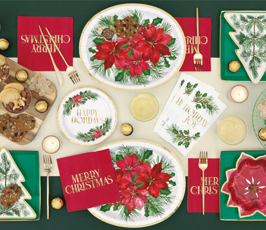 Christmas tablescape with poinsettia plates, napkins, cutlery 