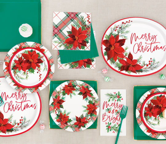 Christmas tablescape with poinsettia plates, napkins, cutlery 