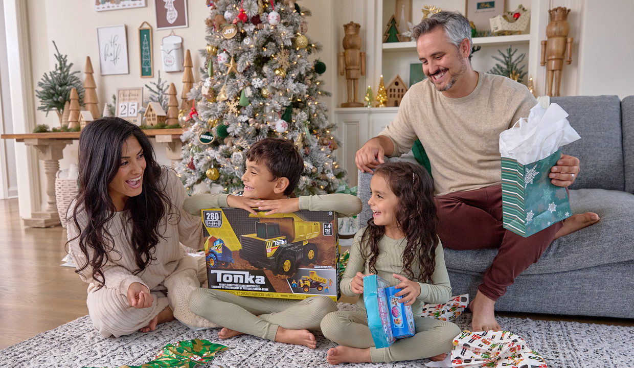 Family opening gifts from pOpshelf together on Christmas morning.