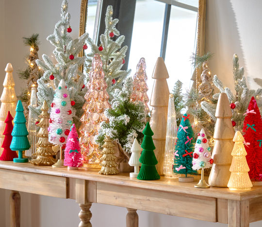 Christmas tree tabletop decor in an array of styles, colors, and materials such as wood, glass, bottlebrush, and more., and more.