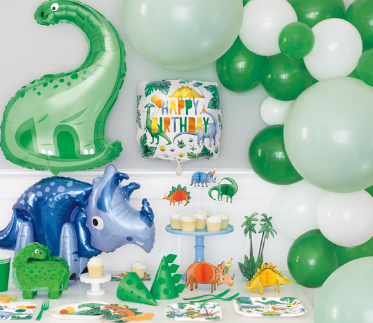 Dinosaur party set with triceratops and brachiosaurus foil balloons, party hats, tableware and decorations.