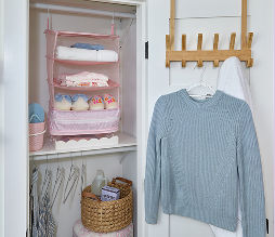 A dorm room closet organized with organizational tools from pOpshelf.
