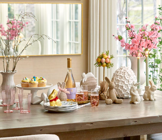Easter brunch drink buffet surrounded by bunny decor and florals