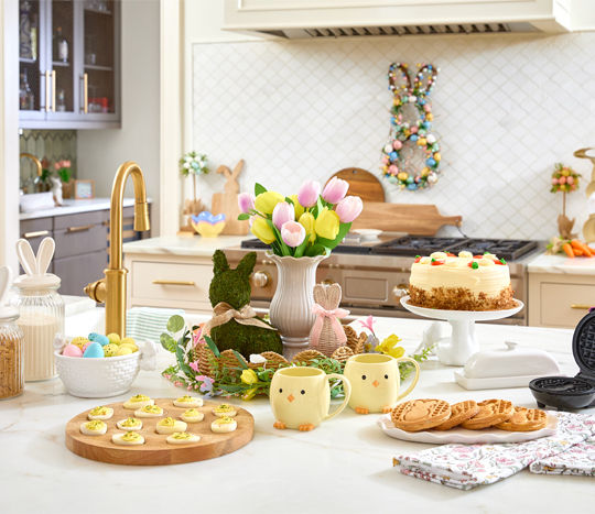 Kitchen with deviled egg tray, white bunny cake stand, Easter serveware, bunny canisters, Easter kitchen towels, and Easter decor.