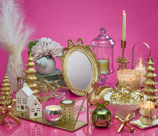 Gift ideas for the decorator from pOpshelf: gold bow candleholders, candles, glass and gold lantern, gold bow mirror, tabletop decor & more.
