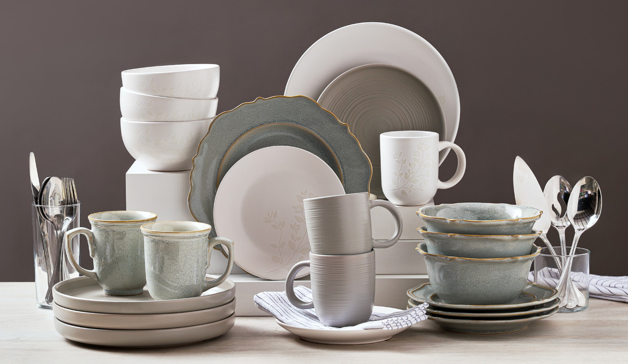 Dinner plates, side plates, bowls, mugs, and soup bowls in whites and grays.