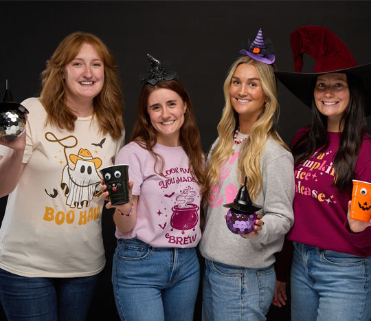 friends wearing Halloween t-shirts, sweatshirts, costume accessories and jewelry from pOpshelf.nail art, makeup brushes, and false eyelashes on a black background.