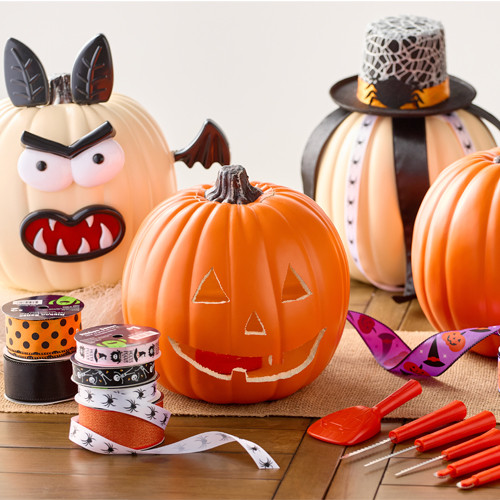 Wooden werewolf and jack-o-lantern paintable masks surrounded by paint tubes, paintbrushes, and pumpkins.  