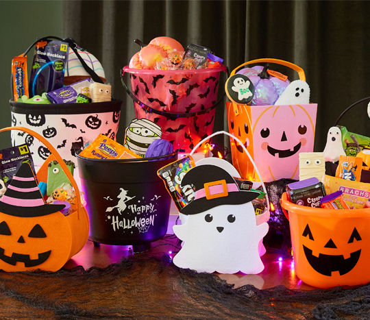 Halloween trick-or-treat buckets and bags filled with candy and goodies from pOpshelf.