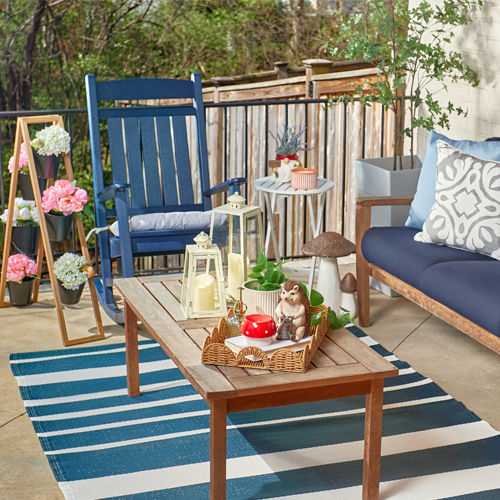 Patio decorated with new lawn & garden decor, pillows, chair cushions, and planters from pOpshelf.