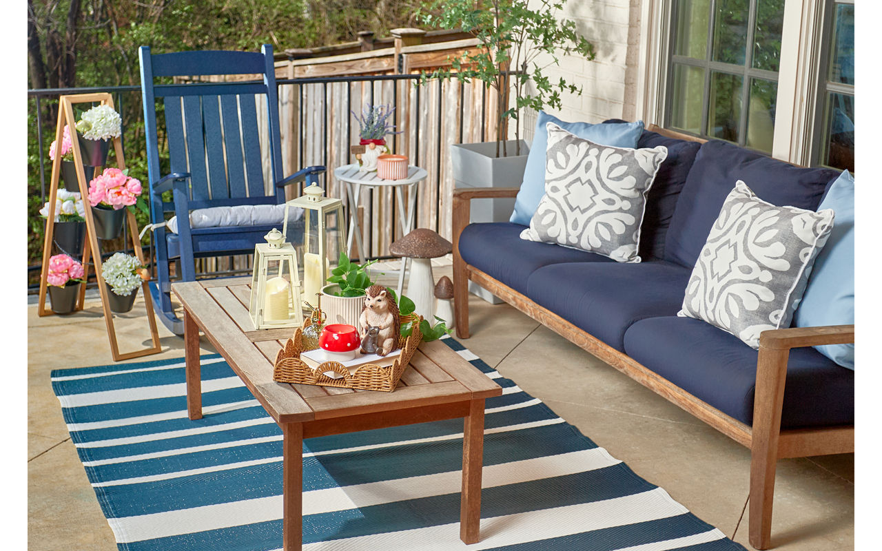 Patio decorated with new lawn & garden decor, pillows, chair cushions, and planters from pOpshelf.