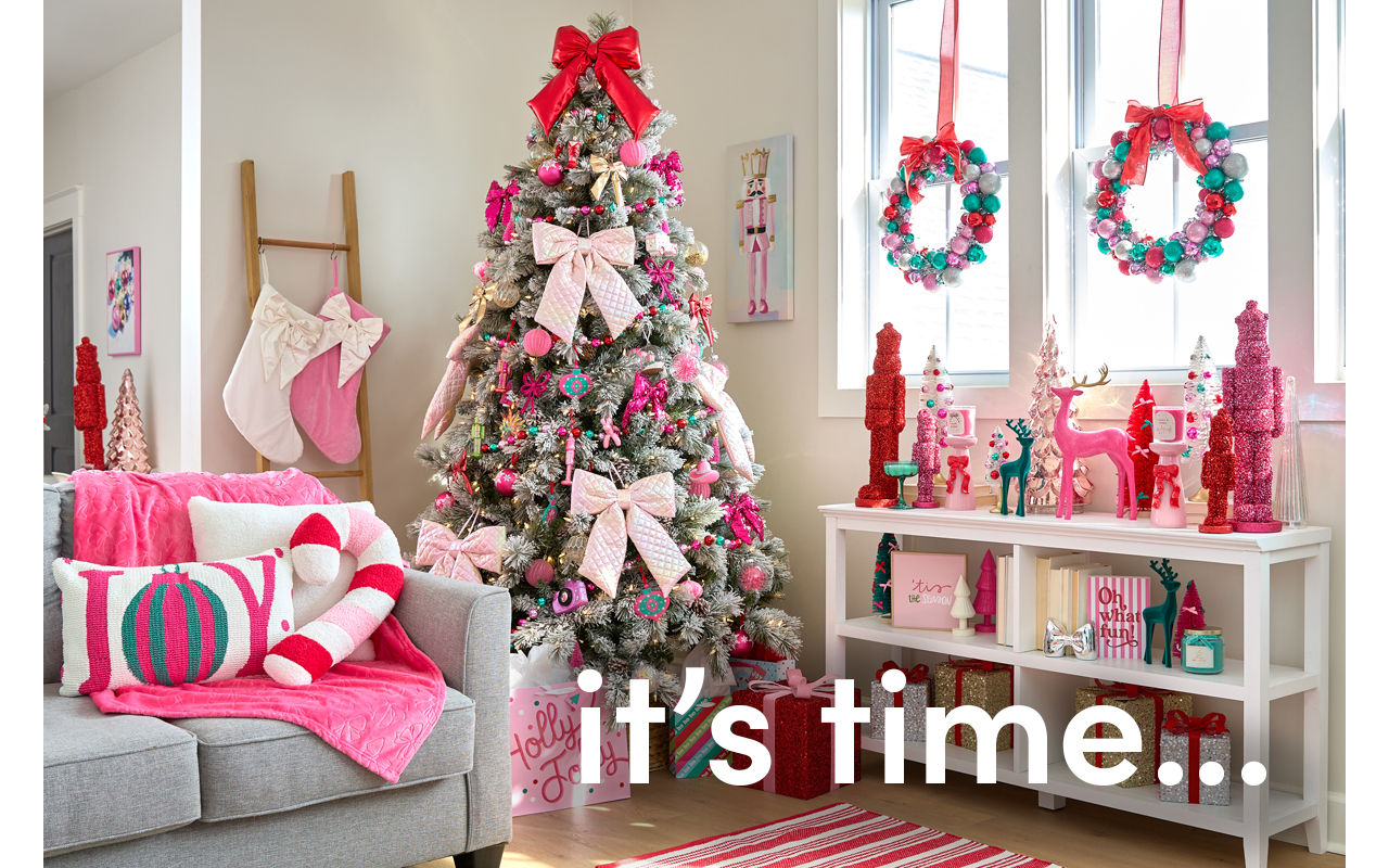 Room decorated with the Merry Merry pink, bows, and sparkly decor collection from pOpshelf: tree ornaments, wall art, pillows, throws, tinsel nutcrackers, bottlebrush trees, candles, ornament wreaths & garland.