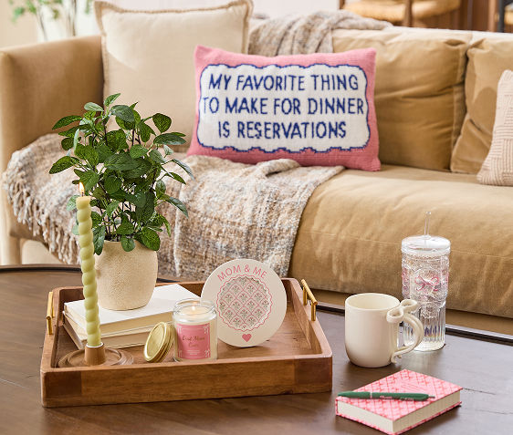 Neutral living room decorated with pink, white, and green accents from Mother’s Day gifts found at pOpshelf.