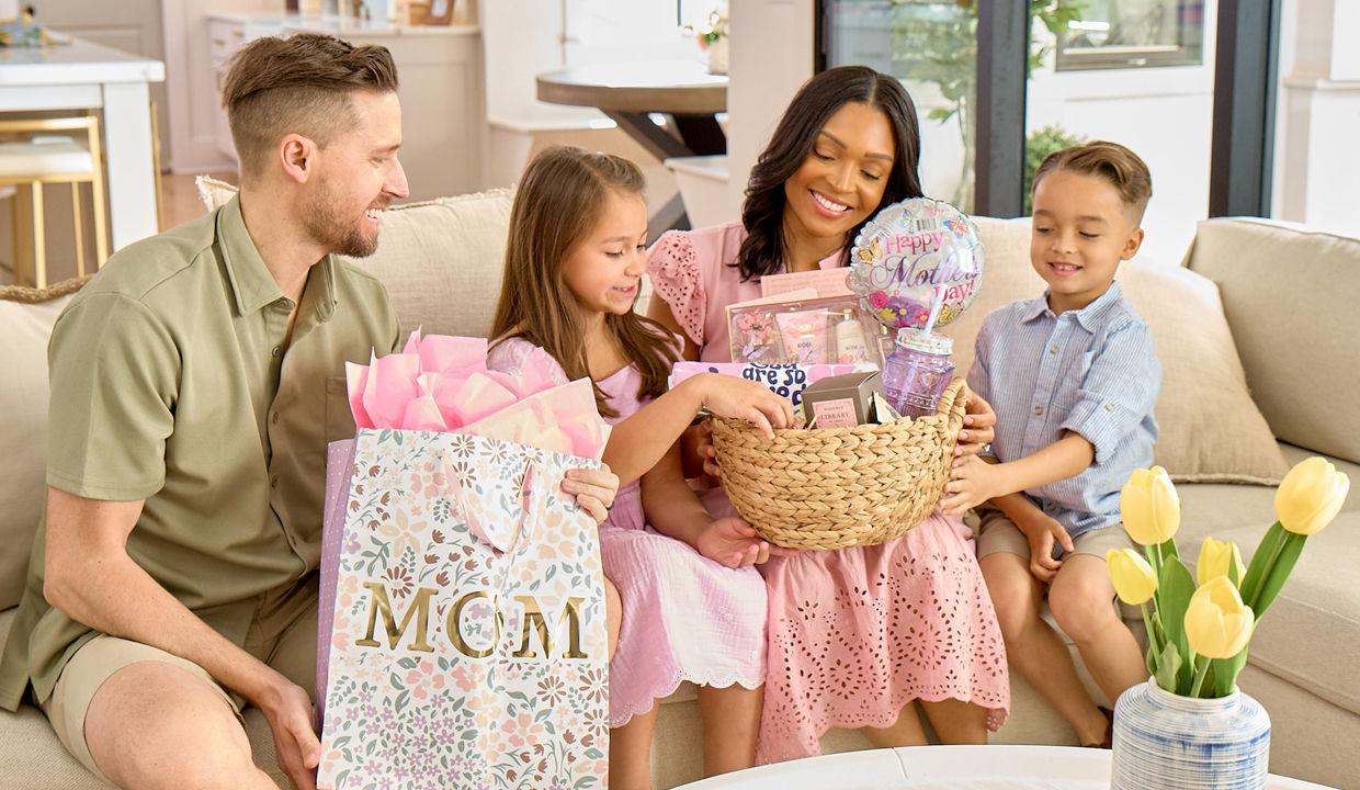 Mother, father, and kids giving mom Mother's Day gifts from pOpshelf.