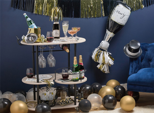 New Year's Eve Bar Cart and Party Supplies from pOpshelf: giant champagne foil balloon, top hats, balloons, gold confetti wine glasses, dublin champagne glasses, and more.