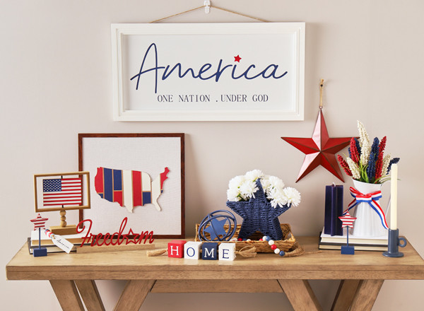 Entryway decorated with red, white, and blue patriotic decor: wall art of states, flag decor, "America" wall art, red metal star, & more.