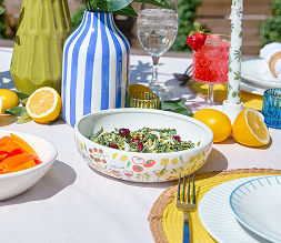 A salad bowl from pOpshelf featuring a colorful coastal tomatoes and pasta print inspired by coastal Italy.