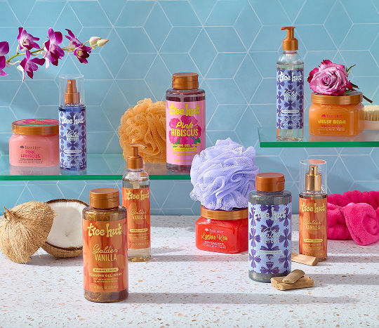 Bathroom shelves with products from Tree Hut are decorated with coconuts, florals, and bathroom accessories from pOpshelf.