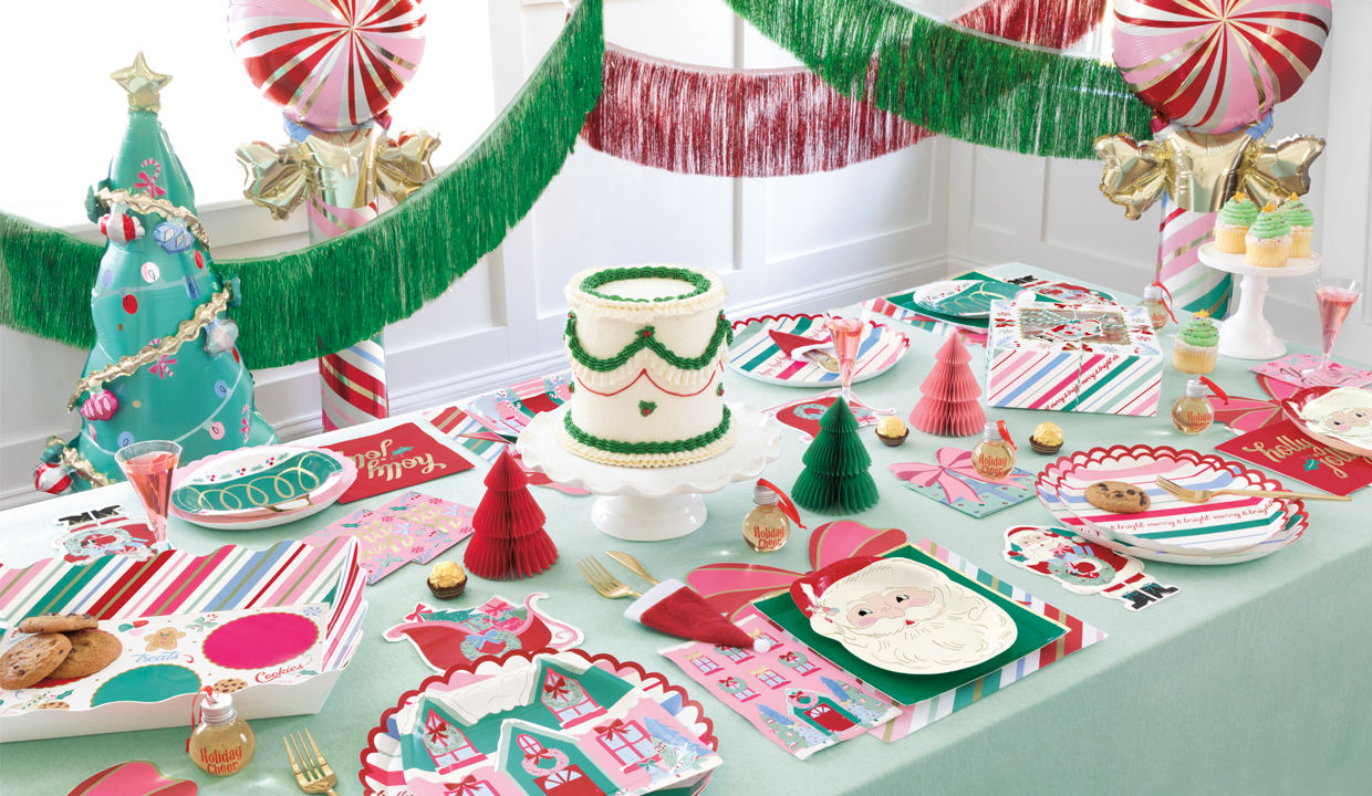 Christmas fun party supplies tablescape with decorative plates, streamers, balloons and more