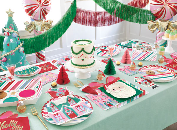 Christmas fun party supplies tablescape with decorative plates, streamers, balloons and more